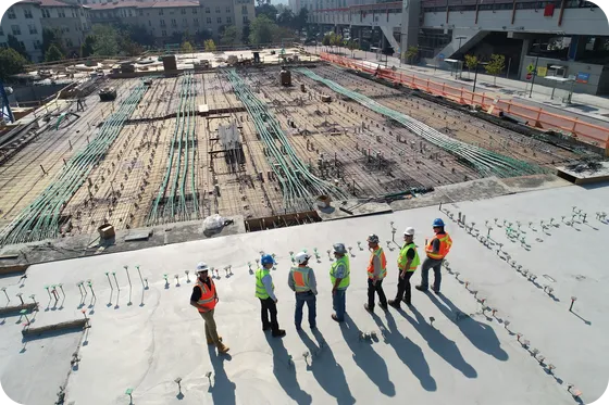 Construction engineers reviewing plans on site