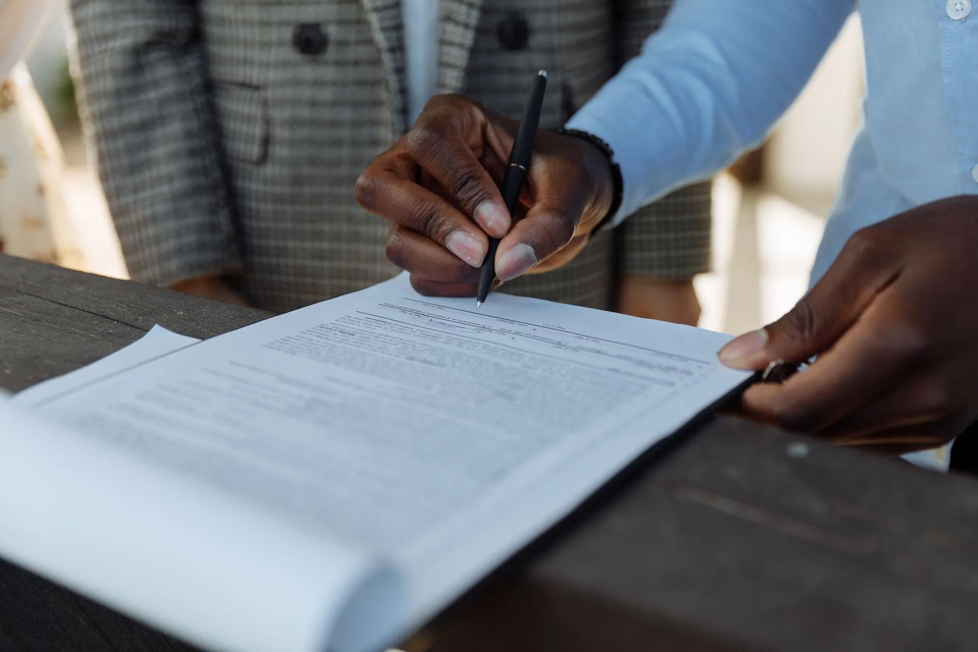 Signing a land document with a pen