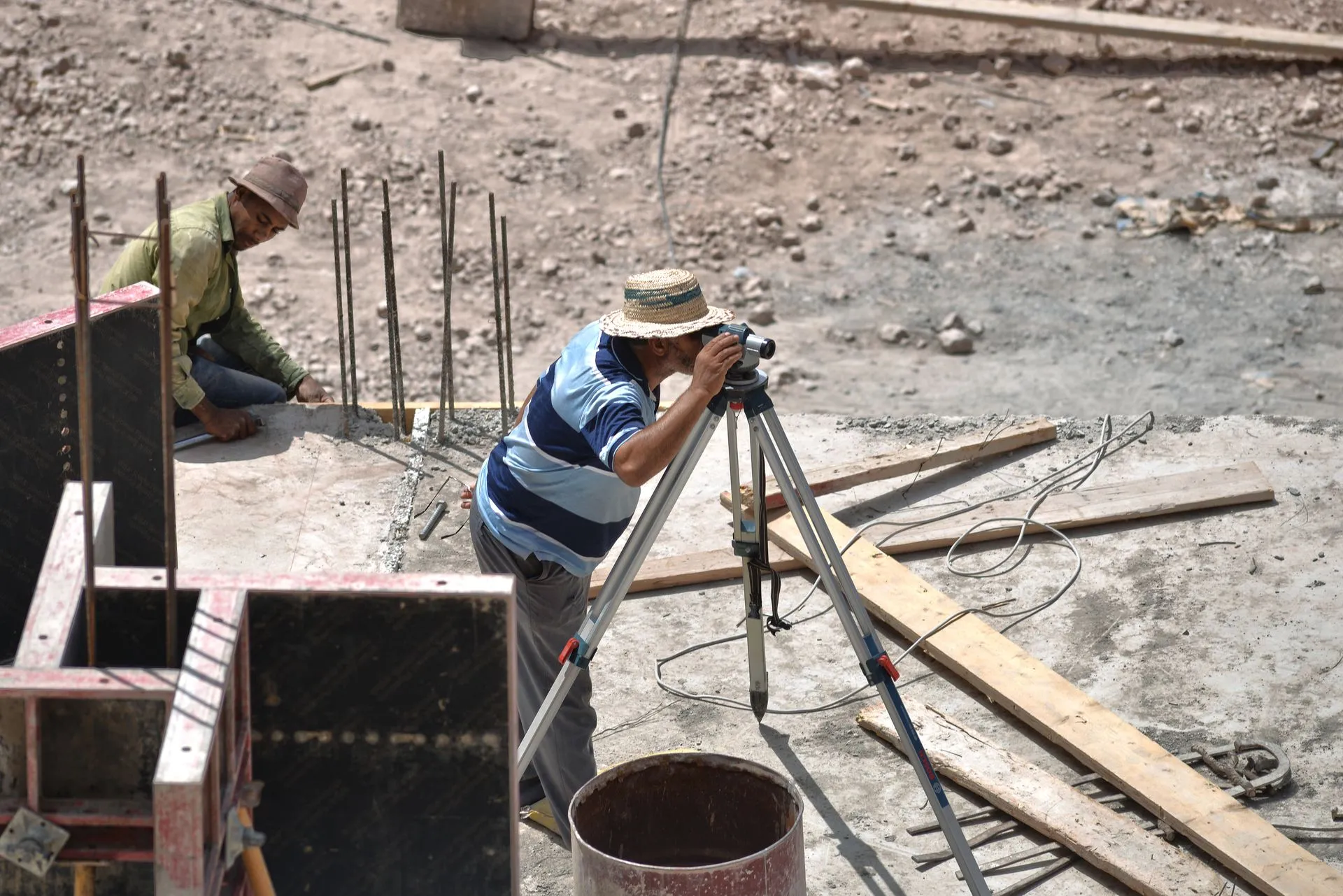 Surveyor using a theodolite outdoors